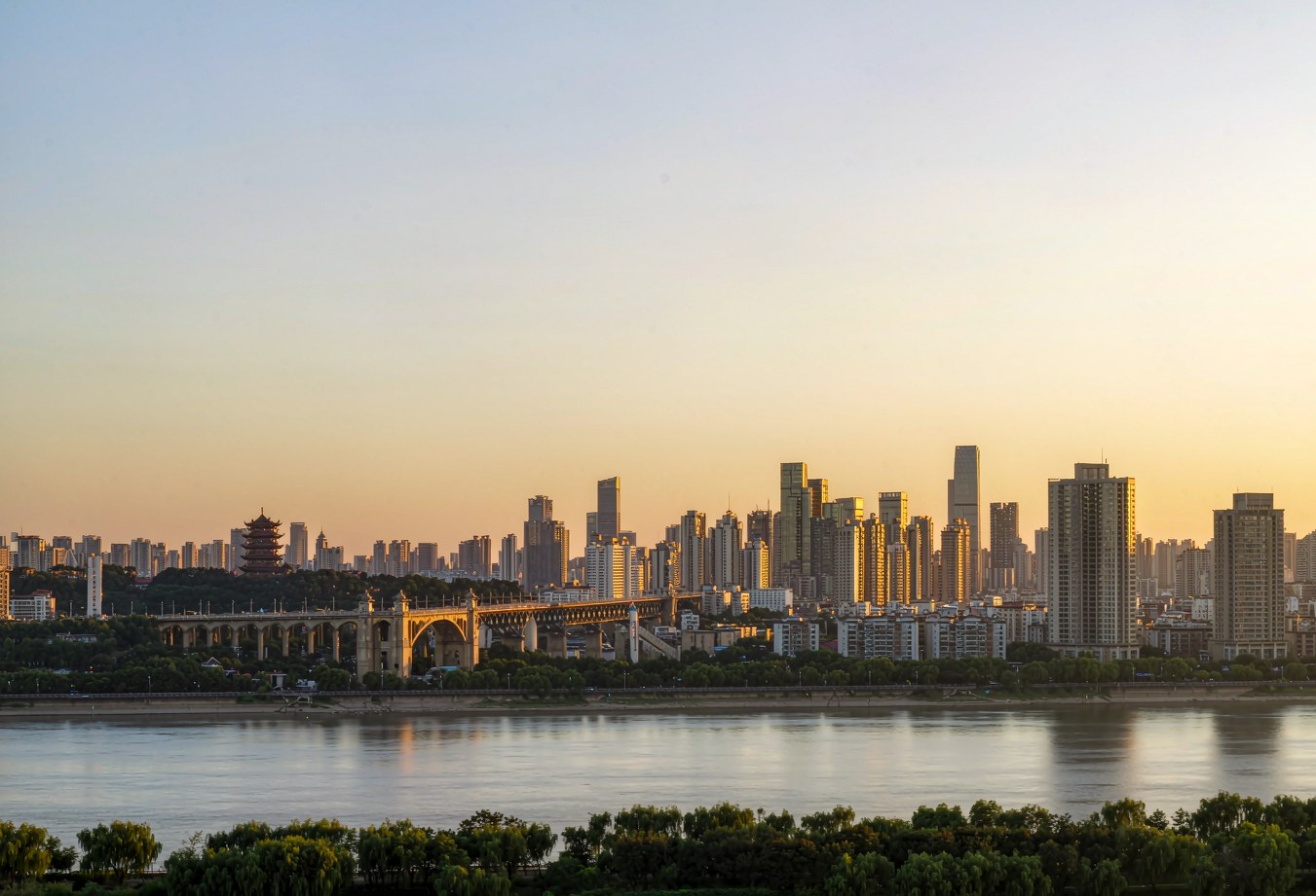 Wuhan skyline at sunset across the Yangtze, with the First Yangtze Bridge